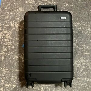 Away The Carry On rolling suitcase with charger and garment insert.